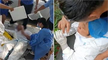 中國高溫飆40度 防疫人員穿「大白」防護衣熱昏